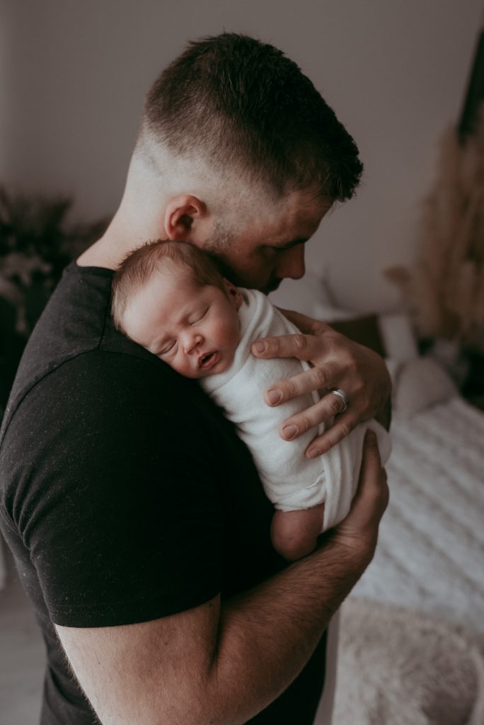 posing newborn with dad