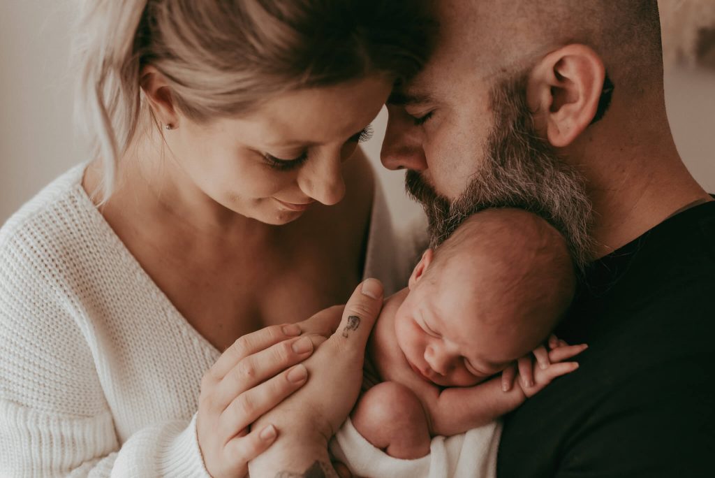 newborn baby with family photographed together