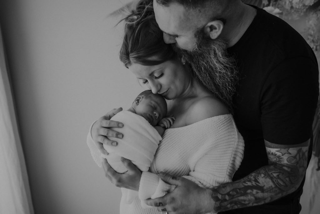 in studio photography with new family of three